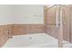 This bathroom features a soaking tub, a tiled shower, and neutral-toned walls at 13206 Meadowmere Rd, Huntersville, NC 28078