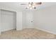 This bedroom features carpet, a ceiling fan, and closet at 13206 Meadowmere Rd, Huntersville, NC 28078
