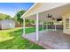 Covered patio with ceiling fans overlooking a fenced backyard with storage shed and green lawn at 13206 Meadowmere Rd, Huntersville, NC 28078