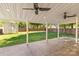 Covered patio featuring ceiling fans, stone flooring, overlooking a fenced backyard with storage shed at 13206 Meadowmere Rd, Huntersville, NC 28078