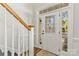 Elegant front entrance with decorative glass door and adjacent staircase, inviting foyer at 13206 Meadowmere Rd, Huntersville, NC 28078