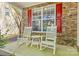 Inviting front porch with stone accents and rocking chairs perfect for relaxing outdoors at 13206 Meadowmere Rd, Huntersville, NC 28078