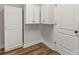 Bright laundry room with white cabinets and modern flooring at 13206 Meadowmere Rd, Huntersville, NC 28078