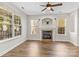 Bright living room with fireplace, large windows, and hardwood floors at 13206 Meadowmere Rd, Huntersville, NC 28078