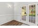 This living room boasts a hardwood floor, a wall of windows, and French doors at 13206 Meadowmere Rd, Huntersville, NC 28078