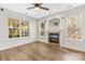 Cozy living room featuring a fireplace and large windows at 13206 Meadowmere Rd, Huntersville, NC 28078