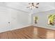 Spacious main bedroom with tray ceiling, ceiling fan and multiple windows at 13206 Meadowmere Rd, Huntersville, NC 28078