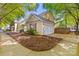 Side view of home featuring a garage, manicured garden, and charming curb appeal at 13206 Meadowmere Rd, Huntersville, NC 28078