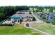 Aerial view of the country club showcasing golf course, clubhouse, pool and ample parking space at 15407 Saxon Trace Ct, Huntersville, NC 28078