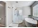 Bright bathroom featuring a glass enclosed shower and soaking tub with wood style flooring at 15407 Saxon Trace Ct, Huntersville, NC 28078