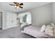 Spacious bedroom featuring large closet, cozy bed, ceiling fan and comfortable lounging area at 15407 Saxon Trace Ct, Huntersville, NC 28078