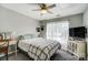 Neutral bedroom featuring a cozy bed, desk area, and ceiling fan for comfort at 15407 Saxon Trace Ct, Huntersville, NC 28078