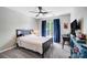 Neutral bedroom with window, desk and ceiling fan that offers a cozy and functional space at 15407 Saxon Trace Ct, Huntersville, NC 28078