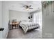 Neutral bedroom with a comfortable bed, desk area, and ceiling fan to create a relaxing space at 15407 Saxon Trace Ct, Huntersville, NC 28078