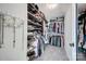 Organized walk-in closet with extensive shelving and hanging rods for clothes and accessories at 15407 Saxon Trace Ct, Huntersville, NC 28078