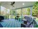 Relaxing covered patio with ceiling fan, stylish outdoor seating, and calming views of the fenced backyard at 15407 Saxon Trace Ct, Huntersville, NC 28078