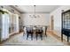 Elegant dining room with a chandelier, wainscoting, and a large window at 15407 Saxon Trace Ct, Huntersville, NC 28078