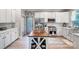 Charming kitchen featuring stainless steel appliances, wooden island with stools, and lots of cabinet space at 15407 Saxon Trace Ct, Huntersville, NC 28078