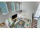 Open concept living room featuring a fireplace, large windows, high ceilings and a ceiling fan at 15407 Saxon Trace Ct, Huntersville, NC 28078