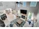 Living room with a fireplace, large TV and hardwood floors that lead to the kitchen at 15407 Saxon Trace Ct, Huntersville, NC 28078