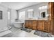 Main bathroom with dual vanity, free standing tub, a walk in shower, and modern fixtures at 15407 Saxon Trace Ct, Huntersville, NC 28078