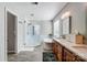 Bathroom featuring dual sinks, a stand alone tub, glass shower and hardwood floors at 15407 Saxon Trace Ct, Huntersville, NC 28078