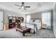 Bedroom featuring neutral paint, a ceiling fan, an ottoman, and updated decor at 15407 Saxon Trace Ct, Huntersville, NC 28078