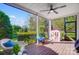 Inviting screened porch featuring a ceiling fan, wooden flooring, and serene views of the landscaped backyard at 15407 Saxon Trace Ct, Huntersville, NC 28078