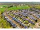 Aerial view of a planned community close to a large green field with many homes on tree-lined streets at 15613 Troubadour Ln, Huntersville, NC 28078