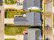 Aerial view showcases the home with a newly stained fence, spacious backyard with a patio and mature trees at 15613 Troubadour Ln, Huntersville, NC 28078