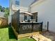 Enjoy a relaxing outdoor space on this home's back deck with attractive privacy screen and sun umbrella at 15613 Troubadour Ln, Huntersville, NC 28078