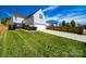 Spacious backyard features lush green grass, a newly stained fence, patio and driveway with two car garage at 15613 Troubadour Ln, Huntersville, NC 28078