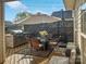 Private backyard patio features modern outdoor seating, overhead umbrella and built-in grill perfect for entertaining at 15613 Troubadour Ln, Huntersville, NC 28078