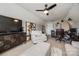 Bright bonus room features neutral carpet, ample seating, ceiling fan, modern art and perfect for a home office setup at 15613 Troubadour Ln, Huntersville, NC 28078