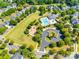 Aerial view of community with a swimming pool, playground, and a green recreation field for outdoor activities at 15613 Troubadour Ln, Huntersville, NC 28078