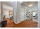 Open foyer with hardwood floors, staircase, and access to the dining and living areas at 15613 Troubadour Ln, Huntersville, NC 28078
