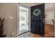 Inviting foyer showcasing beautiful hardwood floors, glass storm door, and a welcoming entrance at 15613 Troubadour Ln, Huntersville, NC 28078