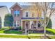 Charming two-story brick home with a welcoming front porch and manicured landscaping at 15613 Troubadour Ln, Huntersville, NC 28078