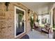 Relaxing front porch with cozy seating area, decorative rug, and charming decor at 15613 Troubadour Ln, Huntersville, NC 28078