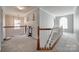 Bright hallway with neutral colors, chandelier, staircase, and sleek decorative accents create an open and inviting atmosphere at 15613 Troubadour Ln, Huntersville, NC 28078