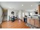 Eat in kitchen with hardwood flooring, stainless steel appliances and a view of the living room at 15613 Troubadour Ln, Huntersville, NC 28078