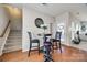 Cozy breakfast nook featuring hardwood flooring, stairway, and lots of natural light at 15613 Troubadour Ln, Huntersville, NC 28078