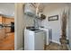 Convenient laundry room located off the kitchen is equipped with appliances, shelving and stylish décor at 15613 Troubadour Ln, Huntersville, NC 28078
