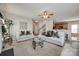 Bright living room featuring neutral paint, plush carpeting, ceiling fan, and easy access to the kitchen at 15613 Troubadour Ln, Huntersville, NC 28078