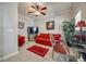 Comfortable living room featuring a red sofa, stylish decor, and bright, neutral walls at 15613 Troubadour Ln, Huntersville, NC 28078