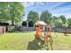 Residential backyard featuring a play set, and a well-maintained lawn and a fence at 17546 Westmill Ln, Charlotte, NC 28277