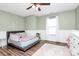 A cozy bedroom with wood floors, a ceiling fan, and half wall trim at 17546 Westmill Ln, Charlotte, NC 28277