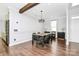 Open dining room featuring modern light fixture, wainscotting and wood flooring at 17546 Westmill Ln, Charlotte, NC 28277