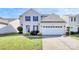 Charming two-story home featuring blue shutters, landscaped yard, and a two-car garage at 17546 Westmill Ln, Charlotte, NC 28277