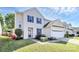 Traditional home with vibrant blue shutters and a well-manicured lawn and landscaping at 17546 Westmill Ln, Charlotte, NC 28277